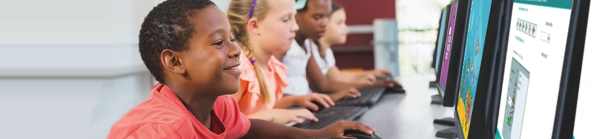 Primary pupils at a row of computers using Spellzone games and activities